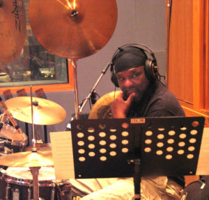 Babatunde Lea, friend and rhythm virtuoso, tuned-in to a studio playback. Photo by Paris Lahman.